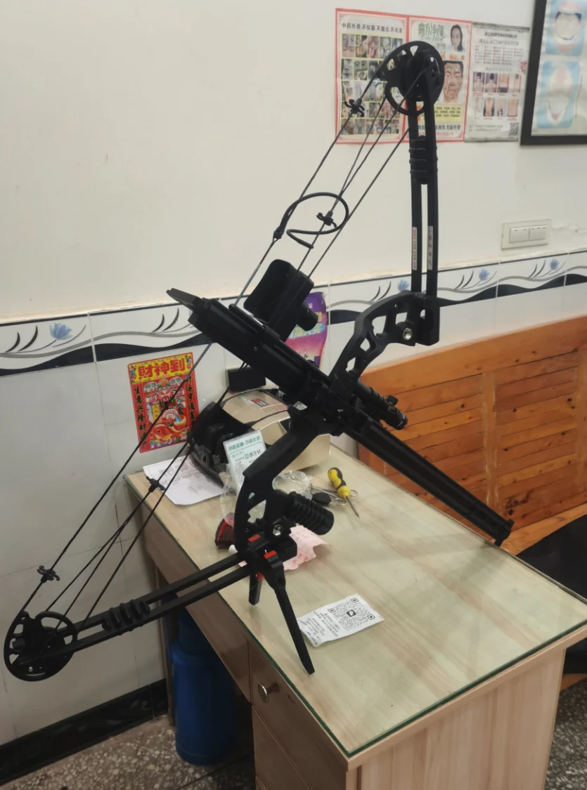 A side view of the assembled bow, photographed indoors on a table.